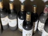 several bottles of wine are lined up on a table
