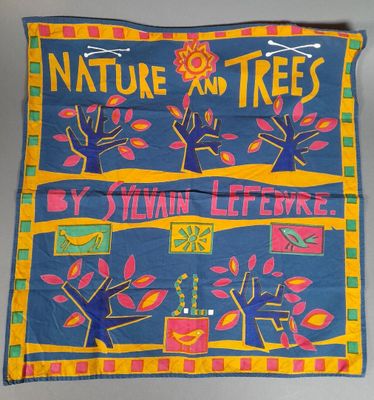 a close up of a blue and yellow banner with trees on it