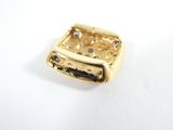 an image of a close up of a gold buckle on a white surface