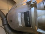 a vacuum that is sitting on a tiled floor