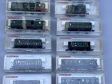a lot of different model trains on display in plastic cases