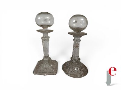 pair of silver candlesticks with glass globes on top