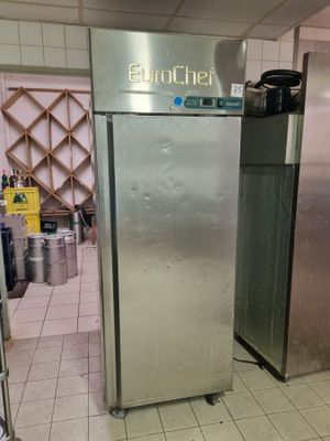 a large stainless steel refrigerator in a kitchen next to other appliances