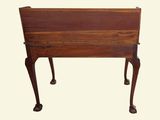 a small wooden table with a drawer on it