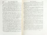 an open book with a black and white image of a cat on it