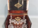 a wooden box filled with wine glasses on a white surface