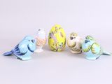 four small birds sitting next to each other on a white surface