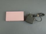 a pink tablet with a charger and a charger on the table
