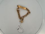 a picture of a white toilet with a gold chain on it
