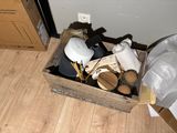 a wooden box filled with various items on the floor