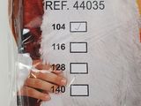 a person in a santa claus costume holding a sign