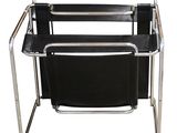 an image of a black chair with a magazine rack on it