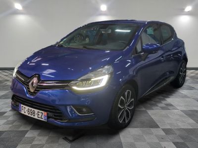 a blue car is parked in a room with a checkered floor
