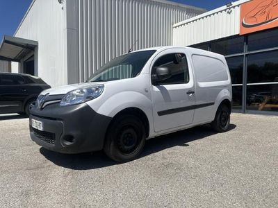 a white van parked in front of a building in a parking lot