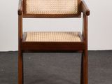 a wooden chair with a woven seat and arm rest