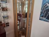 a glass display case in the corner of a room