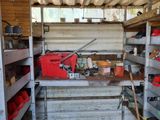 a small room with a lot of shelves and tools in it