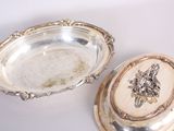 silver plate with a lid and a silver plate with a lion on it