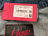 a close up of a wallet and a tag on a pair of jeans