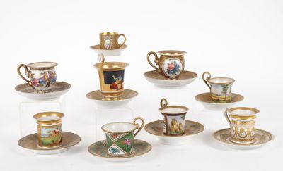 many cups and saucers that are sitting on the table