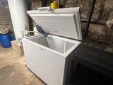 a white chest freezer sitting in a basement
