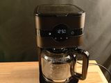 a coffee maker that is sitting on a wooden table