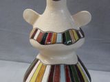 a white vase with a multicolored design on it