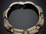 a gold bracelet on a black background