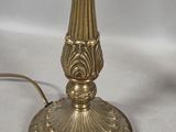 brass plated table lamp with a glass shade on a white background