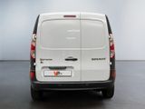 the back of a white van is parked in a room