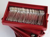 a lot of forks in a red box on a table