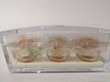 a clear box with four small cupcakes inside of it