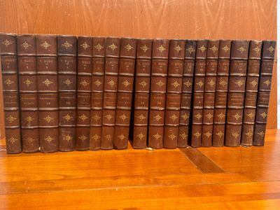 plusieurs vieux livres sont alignés sur une table en bois