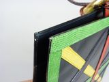 someone is holding a wallet with a colorful design on it