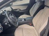 the interior of a car with a tan seat cover and a black steering wheel