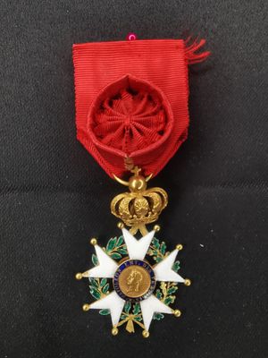 un gros plan d'une médaille entourée d'un ruban rouge