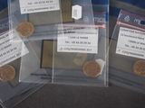 three bags of coins sitting on top of a table next to each other