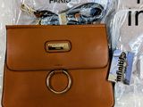 an image of a brown purse with sunglasses and a t - shirt