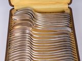a lot of spoons in a case on the table