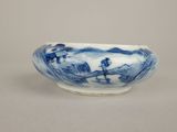 a blue and white bowl with a landscape on it