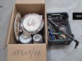 a cardboard box full of assorted items on the sidewalk