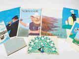 a lot of postcards on a white table