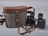 a camera and a pair of binoculars sitting on a table