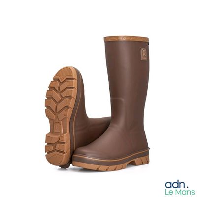 a close up of a pair of brown rain boots on a white background