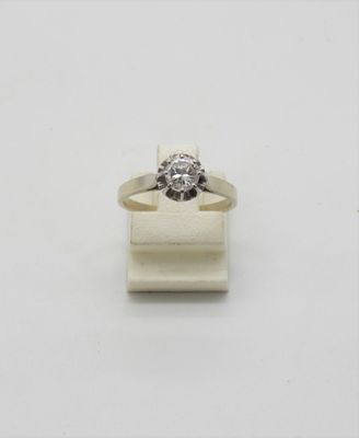 a close up of a diamond ring on a white surface