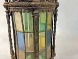 an old fashioned lantern hanging on a white wall with a white background