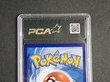 a close up of a pokemon card in a plastic case on a table