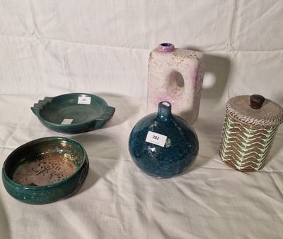 three vases and a bowl on a white table