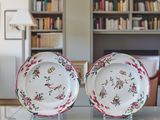 two plates that are sitting on a table in front of a bookshelf