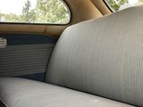 a couch in the back of a car with a window open